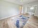 Spacious bedroom with wood-look floors, a ceiling fan, and a mirrored closet at 4430 Wynkoop Cir, Port Charlotte, FL 33948