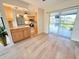 Bright dining area with sliding glass doors, wood floors, and easy access to the kitchen at 4430 Wynkoop Cir, Port Charlotte, FL 33948