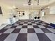 Organized garage with checkerboard flooring and laundry hookups at 4430 Wynkoop Cir, Port Charlotte, FL 33948