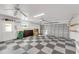 Spacious garage with checkerboard flooring and ample storage space at 4430 Wynkoop Cir, Port Charlotte, FL 33948