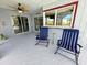 Outdoor lanai featuring chairs, bar window and a view to the pool at 4430 Wynkoop Cir, Port Charlotte, FL 33948