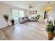 Bright living room features neutral paint, wood floors, and a comfortable gray couch at 4430 Wynkoop Cir, Port Charlotte, FL 33948