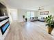 Bright living room features an electric fireplace, wood floors, large windows, and modern decor at 4430 Wynkoop Cir, Port Charlotte, FL 33948