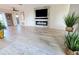 Open living room with electric fireplace, large TV, and light wood floors at 4430 Wynkoop Cir, Port Charlotte, FL 33948