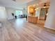 Open floor plan with living and kitchen areas featuring wood floors and neutral colors at 4430 Wynkoop Cir, Port Charlotte, FL 33948
