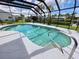 Inviting screened-in pool featuring clear blue water and a convenient handrail for easy access at 4430 Wynkoop Cir, Port Charlotte, FL 33948