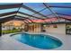 Screened-in pool area with beautiful pool, lovely sunset views, and covered patio space at 4430 Wynkoop Cir, Port Charlotte, FL 33948