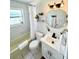Well-lit bathroom with a shower-tub combo and classic fixtures at 4444 Los Rios St, North Port, FL 34287