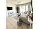 Bright living room with large windows, neutral tones, and a comfortable seating area at 4444 Los Rios St, North Port, FL 34287