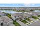 Aerial view shows a neighborhood with a pond, well-maintained lawns, and attractive homes at 4886 Seafoam Trl, Bradenton, FL 34211