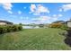 Expansive backyard overlooking a serene pond, enhanced by lush landscaping, and providing a private oasis at 4886 Seafoam Trl, Bradenton, FL 34211