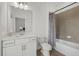 Clean bathroom featuring white cabinetry, a large mirror and a shower-tub combo at 4886 Seafoam Trl, Bradenton, FL 34211