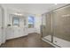 Bright bathroom with a glass-enclosed shower and double vanity with wood-look floors at 4886 Seafoam Trl, Bradenton, FL 34211