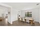 Bright dining room with wooden table and neutral colored chairs, and a large window at 4886 Seafoam Trl, Bradenton, FL 34211