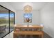 Bright dining area with modern light fixture and view to the backyard and patio at 4886 Seafoam Trl, Bradenton, FL 34211
