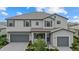 Charming two-story home featuring a well-manicured lawn and a two-car garage at 4886 Seafoam Trl, Bradenton, FL 34211