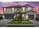 Beautiful two-story home featuring a well-manicured lawn, a two-car garage and colorful sunset at 4886 Seafoam Trl, Bradenton, FL 34211
