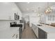 Modern kitchen with stainless steel appliances, a gas range, quartz countertops, and pendant lighting at 4886 Seafoam Trl, Bradenton, FL 34211