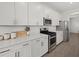 Bright kitchen featuring stainless steel appliances and white cabinets with a large island at 4886 Seafoam Trl, Bradenton, FL 34211