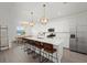Bright kitchen boasts a large island with seating and modern stainless steel appliances at 4886 Seafoam Trl, Bradenton, FL 34211