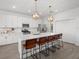 Spacious kitchen with stainless steel appliances, white cabinets, and an island with barstool seating at 4886 Seafoam Trl, Bradenton, FL 34211