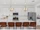 Bright kitchen featuring stainless appliances, white cabinetry, and a large island with seating at 4886 Seafoam Trl, Bradenton, FL 34211