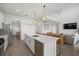 Spacious island kitchen with quartz countertops, pendant lighting, and open view to the living area at 4886 Seafoam Trl, Bradenton, FL 34211