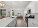 Modern kitchen with white cabinetry, stainless steel appliances, and a quartz countertop island at 4886 Seafoam Trl, Bradenton, FL 34211