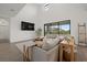 Bright living room with high ceilings, large windows, and stylish modern furniture at 4886 Seafoam Trl, Bradenton, FL 34211