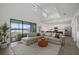 Open-concept living space with a large sectional sofa and natural light, open to the kitchen and dining areas at 4886 Seafoam Trl, Bradenton, FL 34211