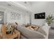 Bright living room with a large sectional sofa, high ceilings, and modern decor at 4886 Seafoam Trl, Bradenton, FL 34211