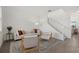 Cozy living room featuring modern decor, a comfortable sofa, and a staircase leading to the second floor at 4886 Seafoam Trl, Bradenton, FL 34211