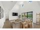 Bright living room featuring high ceilings, modern decor, and sliding glass doors to bring the outdoors in at 4886 Seafoam Trl, Bradenton, FL 34211