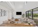 Bright living room with soaring ceilings, neutral tones, and large sliding glass doors to a private backyard at 4886 Seafoam Trl, Bradenton, FL 34211