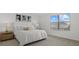 Comfortable bedroom features a large window, neutral walls, and a king-sized bed at 4886 Seafoam Trl, Bradenton, FL 34211