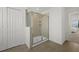 Modern shower with a glass door, neutral tile and wood-look flooring at 4886 Seafoam Trl, Bradenton, FL 34211