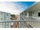 Breathtaking balcony view overlooking a pristine beach and turquoise ocean waters, framed by lush palm trees at 5200 Gulf Dr # 601, Holmes Beach, FL 34217