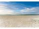 Expansive sandy beach with the calming ocean horizon under a beautiful sky at 5200 Gulf Dr # 601, Holmes Beach, FL 34217