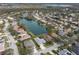Expansive aerial shot showcasing a community with numerous lakefront homes and lush surroundings at 5383 Creekside Trl, Sarasota, FL 34243