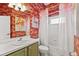 Whimsical bathroom featuring flamingo-themed wallpaper, art, shower curtain and light fixture at 5383 Creekside Trl, Sarasota, FL 34243