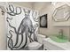 Unique bathroom featuring a striking octopus shower curtain, a green glass vessel sink, and modern fixtures at 5383 Creekside Trl, Sarasota, FL 34243