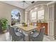 Bright dining room featuring a lovely built-in buffet and a large arched window at 5383 Creekside Trl, Sarasota, FL 34243