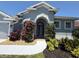 Charming home featuring a decorative archway leading to a beautiful front door and nicely landscaped yard at 5383 Creekside Trl, Sarasota, FL 34243