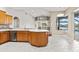 Spacious kitchen with a breakfast bar that opens to the living room and views of the pool area at 5383 Creekside Trl, Sarasota, FL 34243