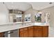 Spacious kitchen with island featuring stainless steel appliances, and open view of the living area and pool at 5383 Creekside Trl, Sarasota, FL 34243