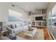 This living room offers lots of natural light, hardwood floors, and plenty of shelving space at 5383 Creekside Trl, Sarasota, FL 34243