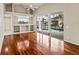 Open living room with hardwood floors, a built-in entertainment center, and views of the screened-in pool at 5383 Creekside Trl, Sarasota, FL 34243