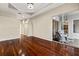 Spacious living room featuring hardwood floors, tray ceiling, and access to the outdoor patio at 5383 Creekside Trl, Sarasota, FL 34243