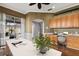 Bright, airy office featuring built-in wood cabinets, a sleek white desk, and serene views of the pool and backyard at 5383 Creekside Trl, Sarasota, FL 34243