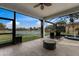Screened in patio with a view of the lake and a ceiling fan at 5383 Creekside Trl, Sarasota, FL 34243